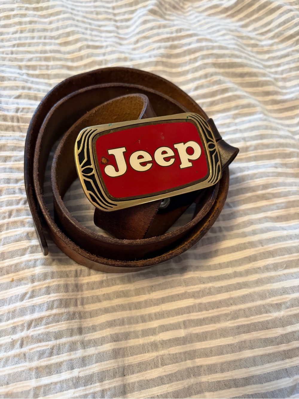 Vintage 1983 Solid Brass Jeep 4x4 belt buckle-Red/White logo on a Peterbilt belt